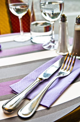place setting - plate, knife and fork on table