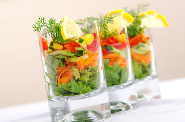 Delicious salad in the glasses