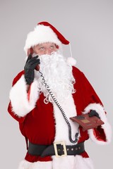 Fototapeta na wymiar Santa on the phone looking up