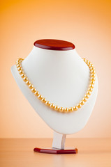 Pearl necklace against gradient background