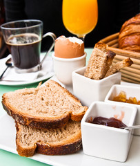 Breakfast with orange juice and fresh fruits on table