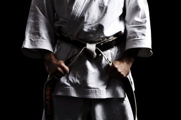 Karate, Schwarzgurt knoten vor schwarz 01 - obrazy, fototapety, plakaty