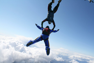 Fototapeta na wymiar Two skydivers exit an airplane