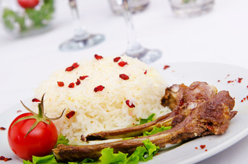 Lamb ribs with rice served in the plate