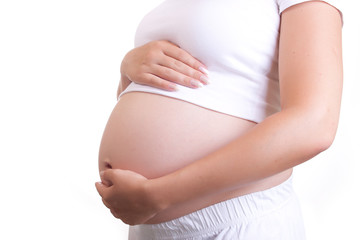 Pregnant woman touching her belly with hands