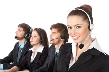 Smiling young businesswoman and colleagues in a call center