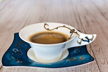Coffee cup on white wood table