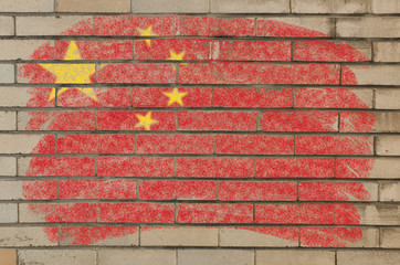 flag of China on grunge brick wall painted with chalk