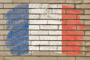 flag of France on grunge brick wall painted with chalk