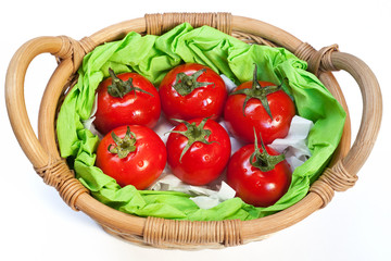 Ripe tomatoes in the woven basket