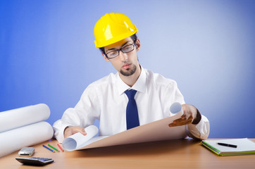 Young engineer looking at drawings