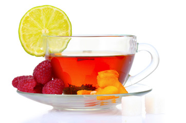 black tea in cup, lime, peach and raspberry isolated on white