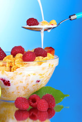 tasty cornflakes, fruit and milk in glass bowl