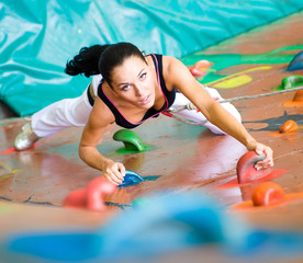 women climbing on a wall