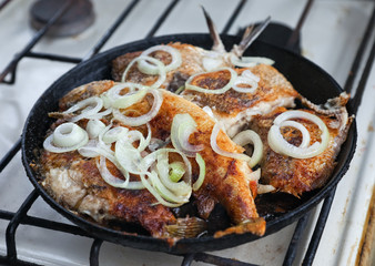 Fried fish in a frying pan