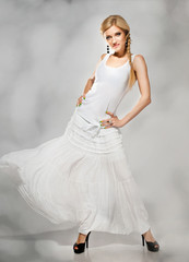Fototapeta na wymiar beautiful fashion blonde in white dress
