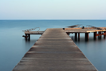 Fototapeta premium Long exposure on wooden pier at dawn