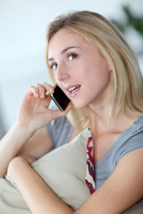 Beautiful woman talking on mobilephone at home