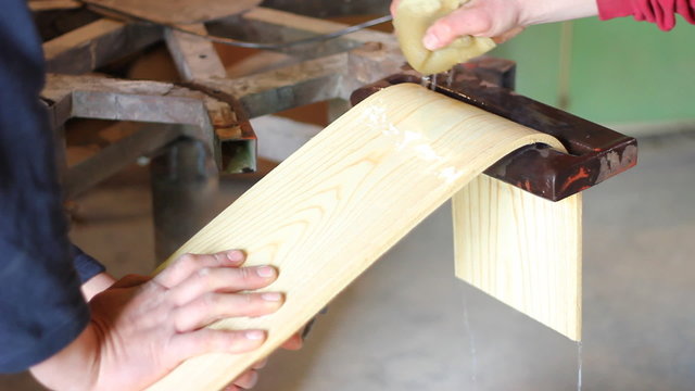 Carpenter bending wooden board