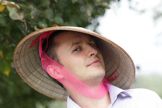Tourist in vietnam hat in park