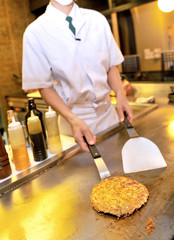 Chef cooks meat at restaurant kitchen