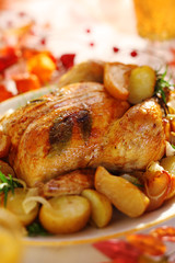Whole roasted chicken with potatoes and apples