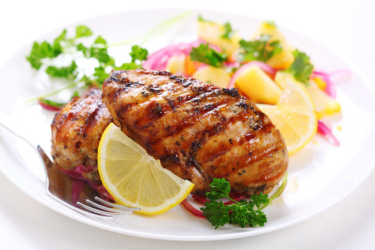 Grilled chicken breast on white plate