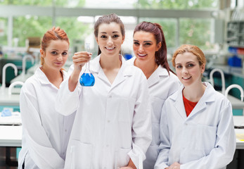 Fototapeta premium Lab partners posing with a flask