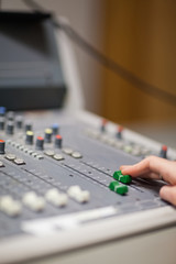 Portrait of a hand setting the sound