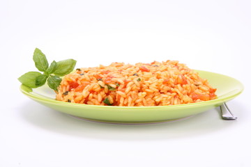 Fototapeta na wymiar Risotto with tomatoes decorated with basil