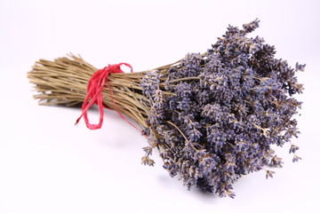 Naklejka premium Bunch of dried lavender tied with a red string on white