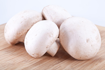Field mushrooms on a wooden board