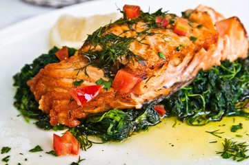 grilled salmon and lemon - french cuisine dish with tomato and s