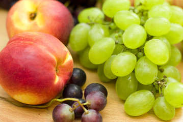 Fresh fruits, grapes and peaches on the table