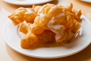 Fried dessert topped milk