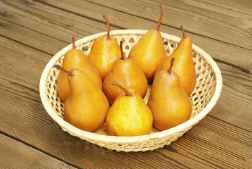 pears in basket, on wooden table