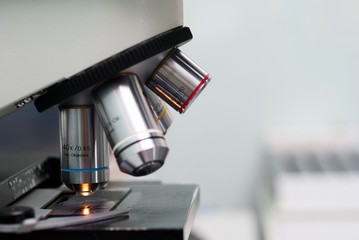 Microscope in lab on gray