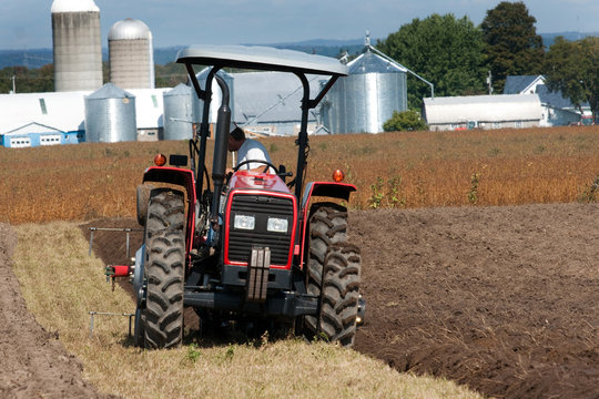 Farmer plowing the soil