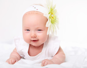 Portrait of a baby girl with a flower on her head
