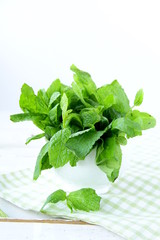 bunch of fresh green mint on wooden cutting board