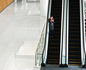 people rushing on escalator