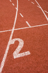 Number two on the start of a running track