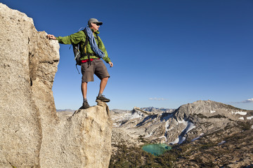 Rock climber celebrates on the summit.