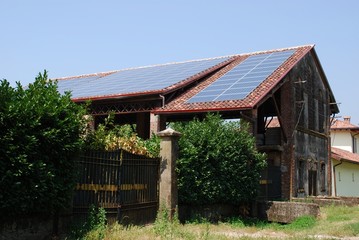 Fototapeta na wymiar Solar panels on the roof of a farm for ecologic energy