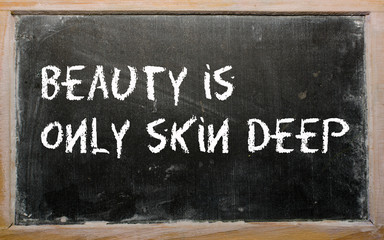 "Beauty is only skin deep" written on a blackboard