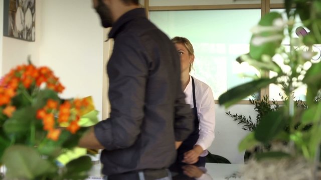 Sales manager at counterand client shopping in flowers shop