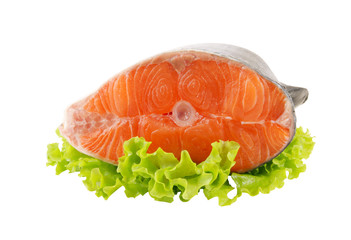 Salmon steak with greens isolated on white