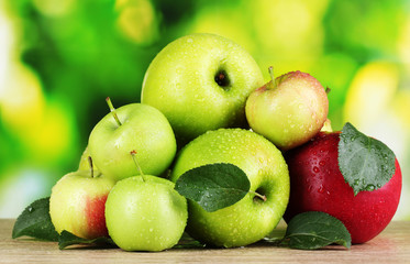 Fresh organic apples on wooden table isolated on white