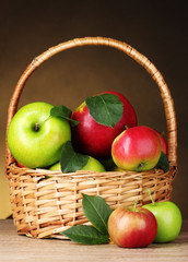 Basket of organic apples on brown background