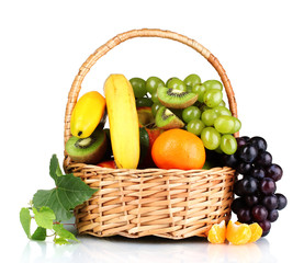 Ripe juicy fruits in  basket isolated on white